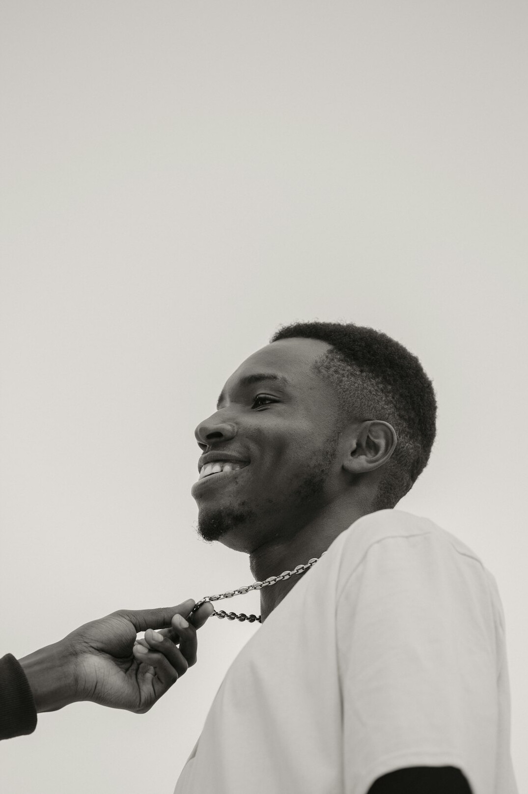 Studio portrait of a man with short hair smiling